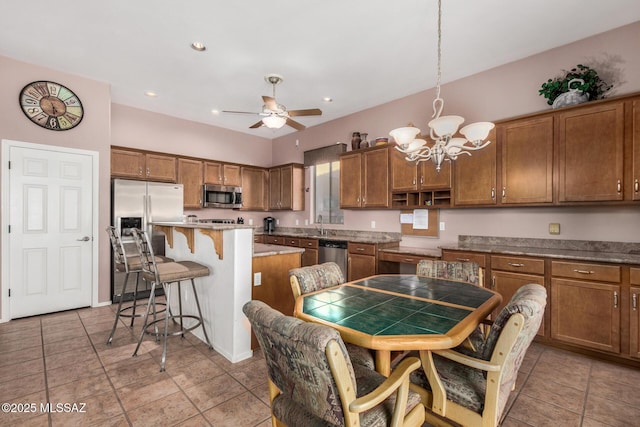 60621 E Eagle Heights Dr, Tucson, AZ 85739 - kitchen featuring brown cabinets, appliances with stainless steel finishes, and a breakfast bar