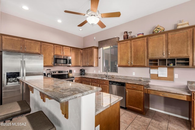 60621 E Eagle Heights Dr, Tucson, AZ 85739 - kitchen with brown cabinets, ceiling fan, appliances with stainless steel finishes, and a sink