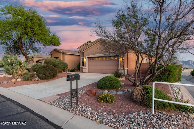 60621 E Eagle Heights Dr, Tucson, AZ 85739 - view of front of home with a garage, stucco siding, and driveway