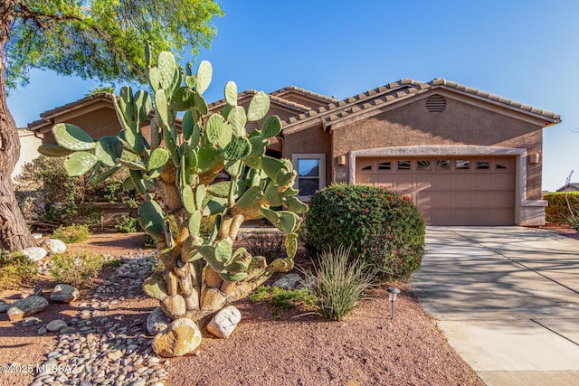 60621 E Eagle Heights Dr, Tucson, AZ 85739 - view of front facade featuring an attached garage, stucco siding, driveway, and a tiled roof