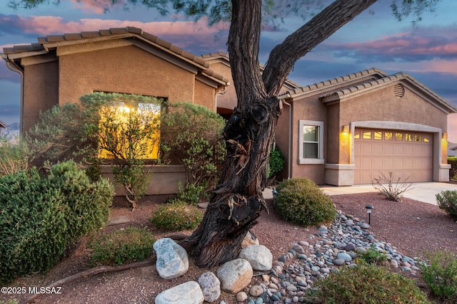 60621 E Eagle Heights Dr, Tucson, AZ 85739 - ranch-style home featuring a tiled roof, an attached garage, driveway, and stucco siding