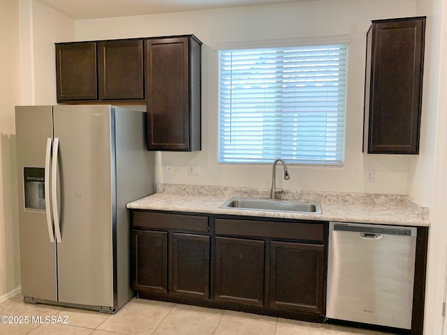 kitchen with a sink, dark brown cabinets, appliances with stainless steel finishes, and a wealth of natural light