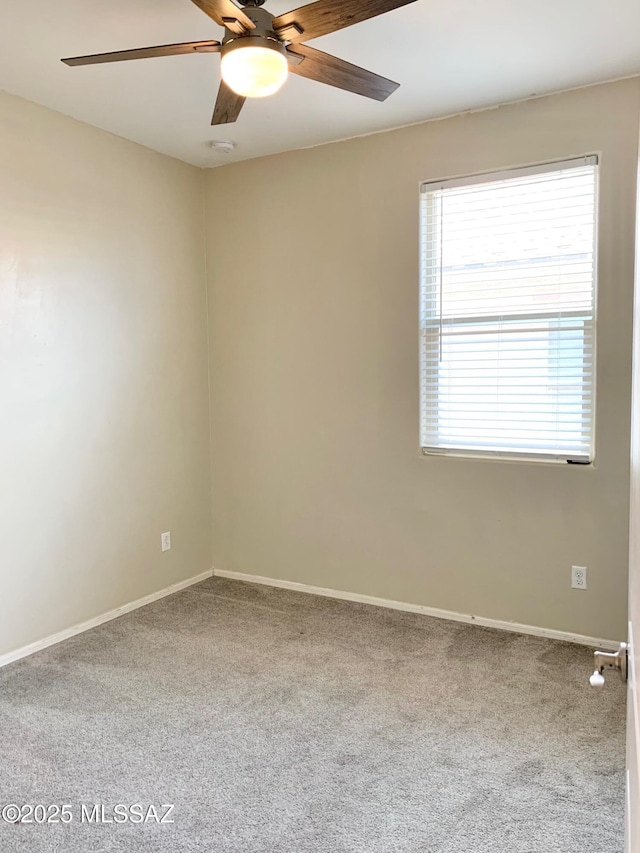 unfurnished room featuring a ceiling fan, carpet flooring, and baseboards