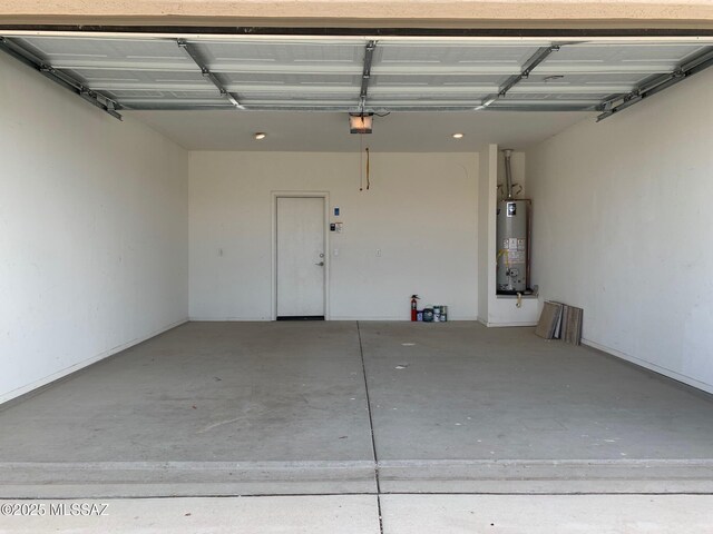 garage with a garage door opener and gas water heater