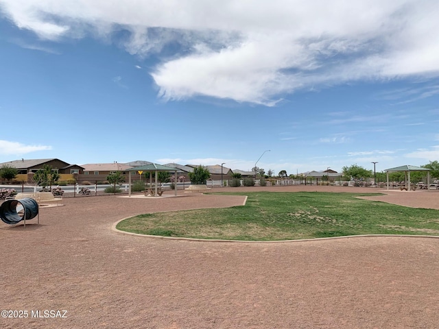 view of home's community featuring fence, a gazebo, and a yard