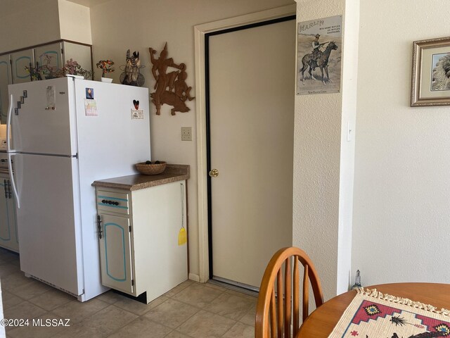 1208 E Flynn Jans Ct, Pearce, AZ 85625 - kitchen featuring light tile patterned flooring and freestanding refrigerator