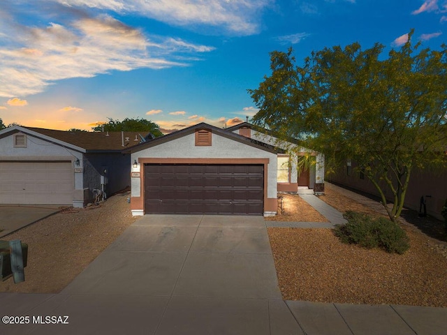 ranch-style home with stucco siding and driveway