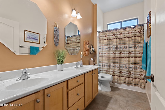 full bath featuring double vanity, toilet, a sink, and tile patterned flooring