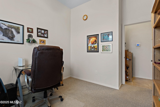 carpeted office featuring baseboards
