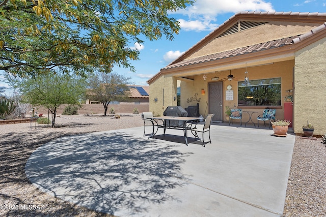 view of patio / terrace with a ceiling fan, fence, and outdoor dining space