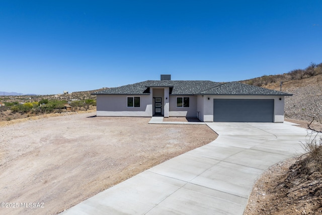 172 Vereda Cabrilla Ln, Rio Rico, AZ 85648 - prairie-style house with a garage, a shingled roof, stucco siding, and driveway