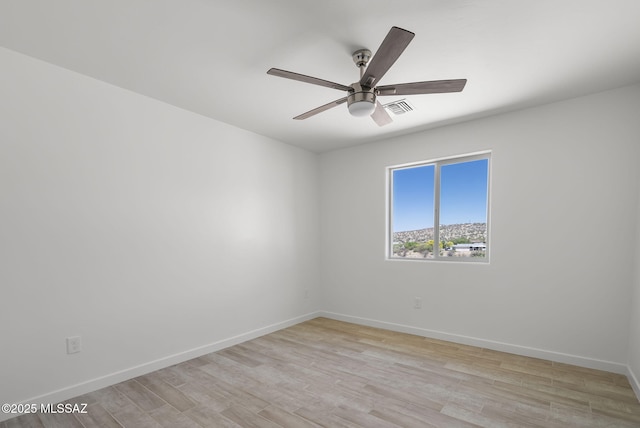 172 Vereda Cabrilla Ln, Rio Rico, AZ 85648 - unfurnished room with ceiling fan, visible vents, light wood-type flooring, and baseboards
