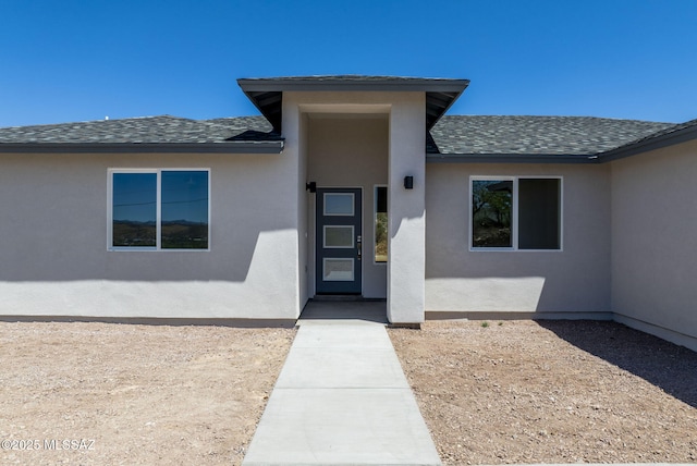 172 Vereda Cabrilla Ln, Rio Rico, AZ 85648 - view of exterior entry featuring stucco siding and a shingled roof