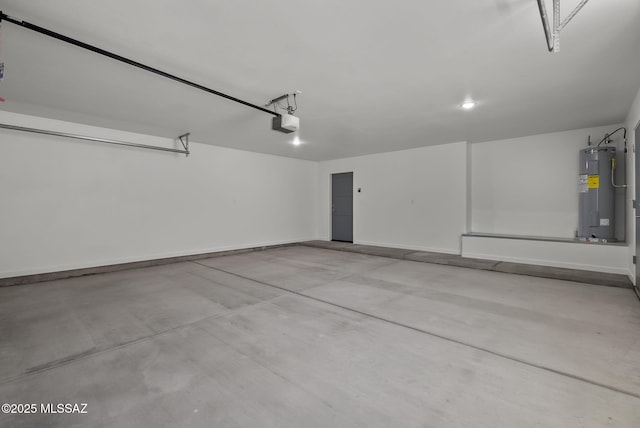 172 Vereda Cabrilla Ln, Rio Rico, AZ 85648 - garage featuring a garage door opener, electric water heater, and baseboards