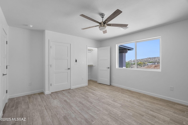 172 Vereda Cabrilla Ln, Rio Rico, AZ 85648 - unfurnished bedroom with baseboards, visible vents, ceiling fan, and light wood-style flooring