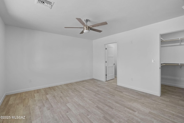172 Vereda Cabrilla Ln, Rio Rico, AZ 85648 - unfurnished bedroom with visible vents, light wood-style flooring, and a spacious closet