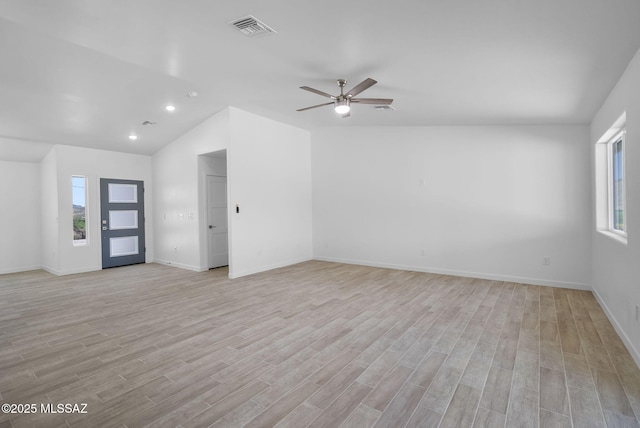 172 Vereda Cabrilla Ln, Rio Rico, AZ 85648 - unfurnished living room with a healthy amount of sunlight, visible vents, vaulted ceiling, and baseboards