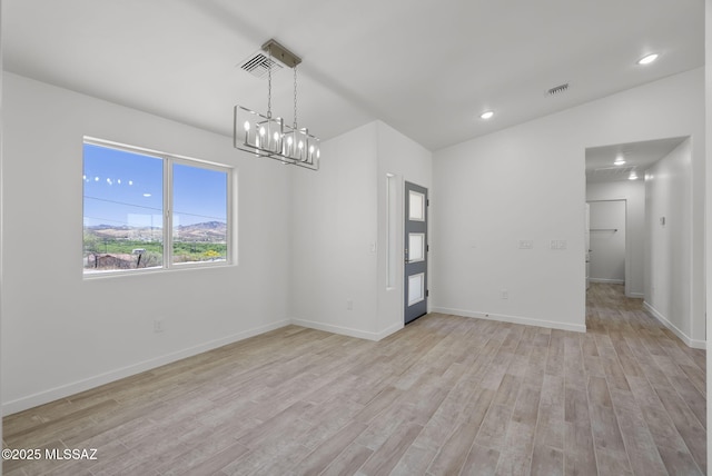 172 Vereda Cabrilla Ln, Rio Rico, AZ 85648 - empty room with a chandelier, visible vents, light wood-style flooring, and baseboards