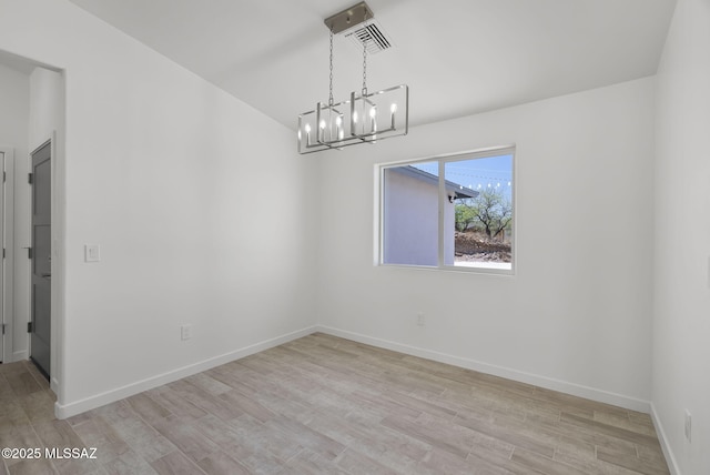 172 Vereda Cabrilla Ln, Rio Rico, AZ 85648 - unfurnished room with visible vents, an inviting chandelier, baseboards, and light wood-type flooring