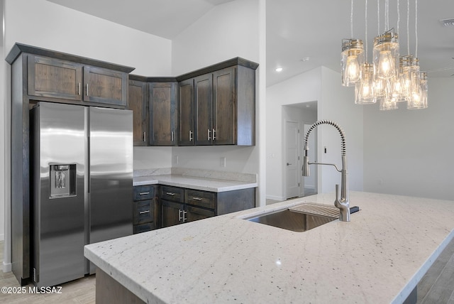 172 Vereda Cabrilla Ln, Rio Rico, AZ 85648 - kitchen featuring stainless steel refrigerator with ice dispenser, dark brown cabinetry, vaulted ceiling, and a sink