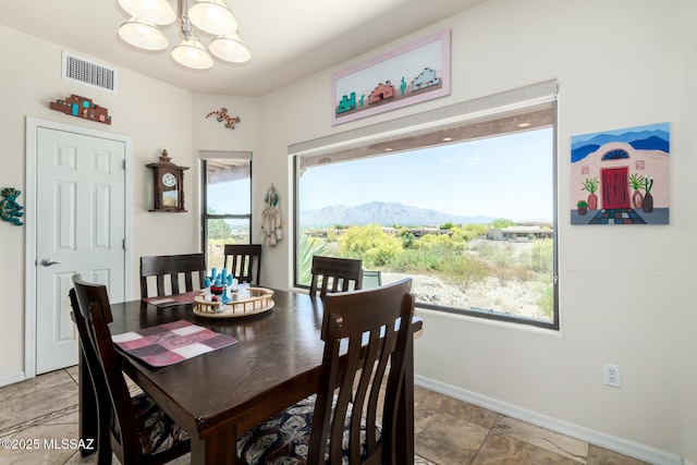 5498 N Desert Wood Pl, Tucson, AZ 85745 - dining space featuring an inviting chandelier, baseboards, a mountain view, and visible vents