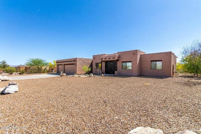 5498 N Desert Wood Pl, Tucson, AZ 85745 - southwest-style home featuring an attached garage, concrete driveway, and stucco siding