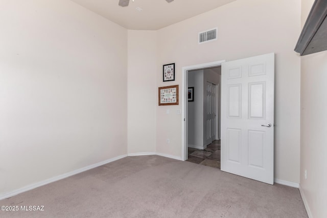 5498 N Desert Wood Pl, Tucson, AZ 85745 - unfurnished bedroom featuring baseboards, visible vents, and light colored carpet
