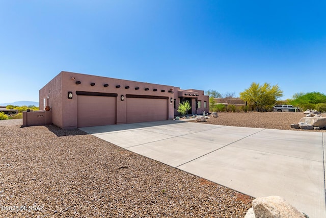 5498 N Desert Wood Pl, Tucson, AZ 85745 - view of front of home with a garage, stucco siding, and driveway