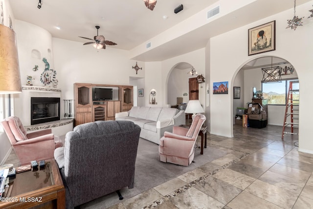 5498 N Desert Wood Pl, Tucson, AZ 85745 - living room featuring arched walkways, ceiling fan, baseboards, and visible vents