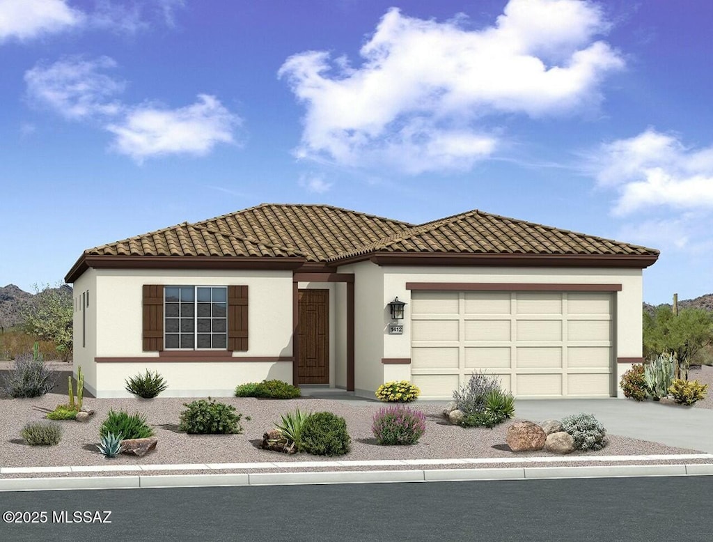 view of front of home featuring driveway, a tiled roof, stucco siding, and an attached garage