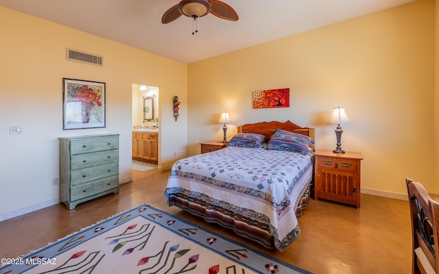 bedroom with a ceiling fan, visible vents, a sink, baseboards, and ensuite bath