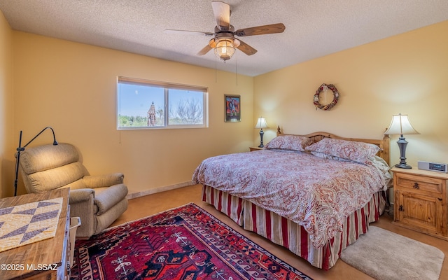 bedroom with carpet floors, a ceiling fan, and a textured ceiling
