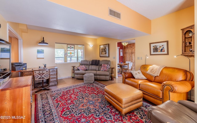 living area featuring baseboards and visible vents