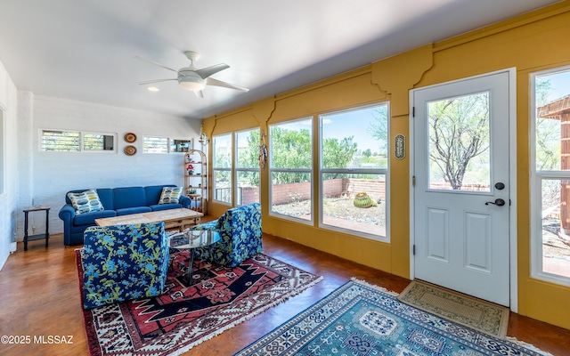 living area featuring a ceiling fan