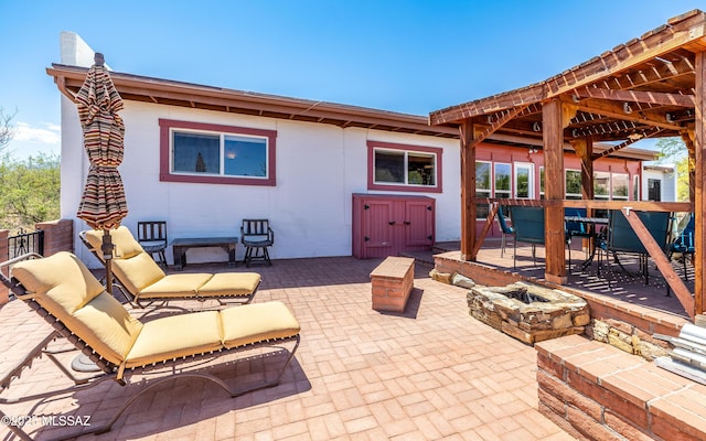 view of patio / terrace featuring an outdoor fire pit