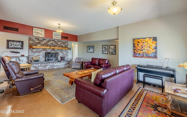 living room with a brick fireplace and visible vents