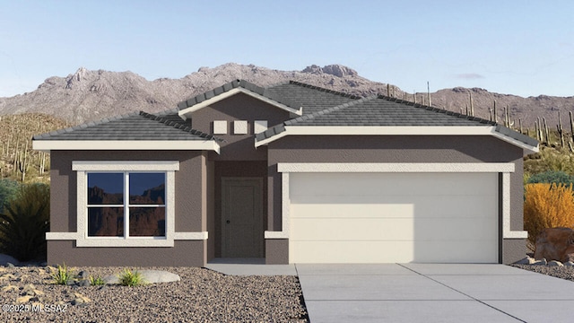 9828 E Gray Hawk Dr, Tucson, AZ 85730 - view of front of house with driveway, a mountain view, an attached garage, and stucco siding