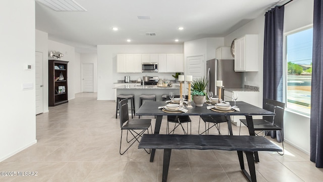 9828 E Gray Hawk Dr, Tucson, AZ 85730 - dining room featuring light tile patterned floors, recessed lighting, visible vents, and baseboards