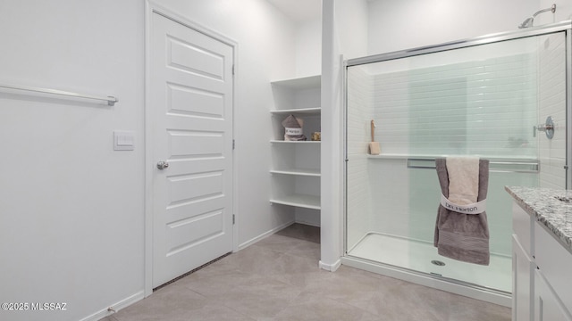 9828 E Gray Hawk Dr, Tucson, AZ 85730 - full bathroom with baseboards, a shower stall, tile patterned flooring, and vanity