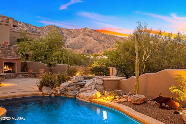 6340 N Placita Alta Reposa, Tucson, AZ 85750 - view of pool featuring a mountain view, fence, an outdoor stone fireplace, and a patio area