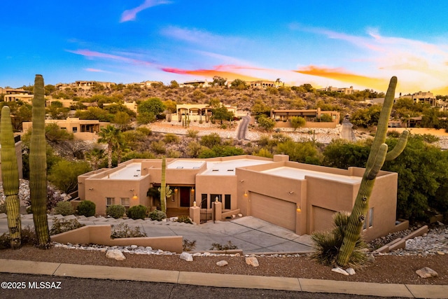 6340 N Placita Alta Reposa, Tucson, AZ 85750 - pueblo-style home with driveway, a chimney, stucco siding, and a garage