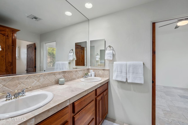 6340 N Placita Alta Reposa, Tucson, AZ 85750 - full bathroom with stone finish flooring, visible vents, tasteful backsplash, and a sink