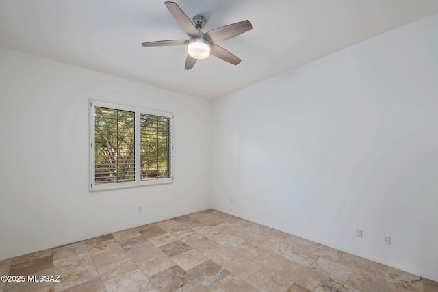 6340 N Placita Alta Reposa, Tucson, AZ 85750 - empty room with a ceiling fan and stone finish floor