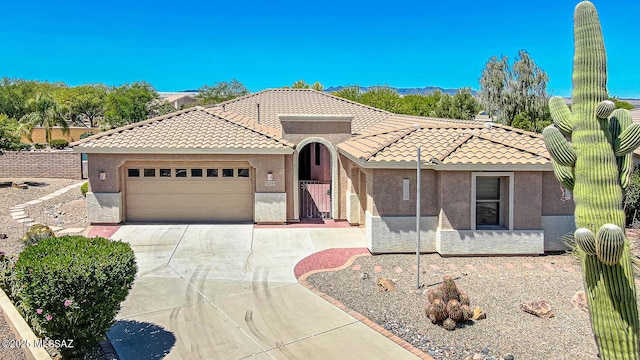 view of front of property featuring driveway, stucco siding, and a tiled roof