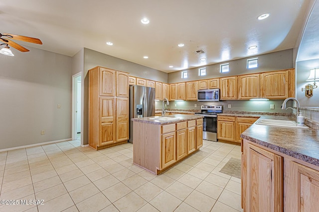 kitchen featuring ceiling fan, stainless steel appliances, visible vents, and a sink