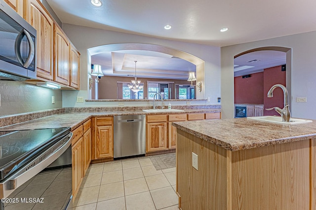 kitchen featuring a chandelier, stainless steel appliances, recessed lighting, and a sink