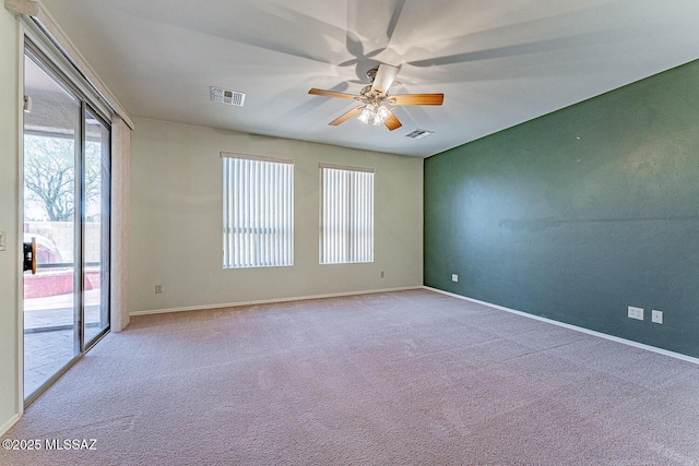 spare room with visible vents, ceiling fan, and carpet floors