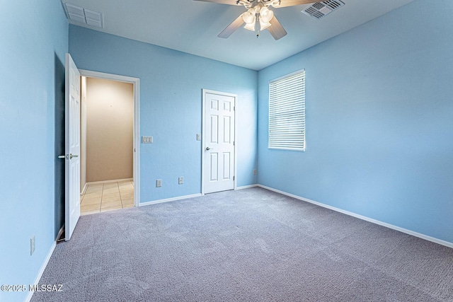 unfurnished bedroom with visible vents, ceiling fan, carpet floors, and baseboards