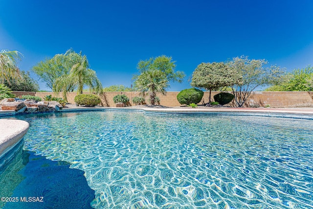 view of swimming pool featuring a fenced in pool and a fenced backyard