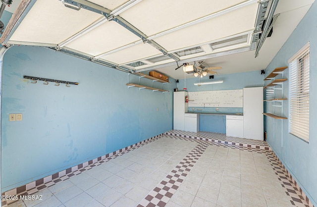 garage featuring a garage door opener and ceiling fan